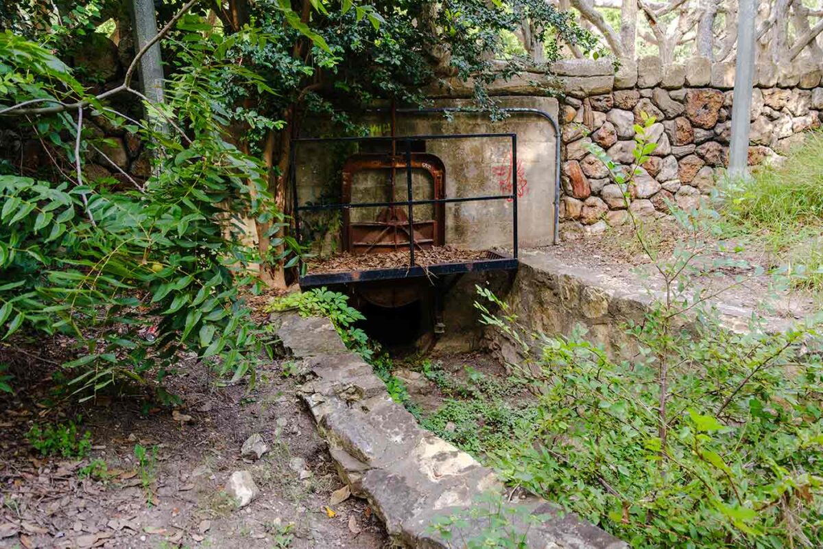 Damaged and deteriorated Upper Labor Dam Acequia composed of grouted stone walls